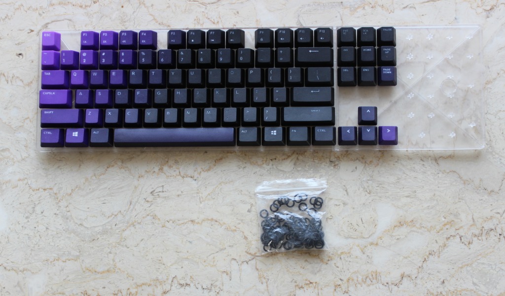 The replacement Keycaps and the Silencer rings.